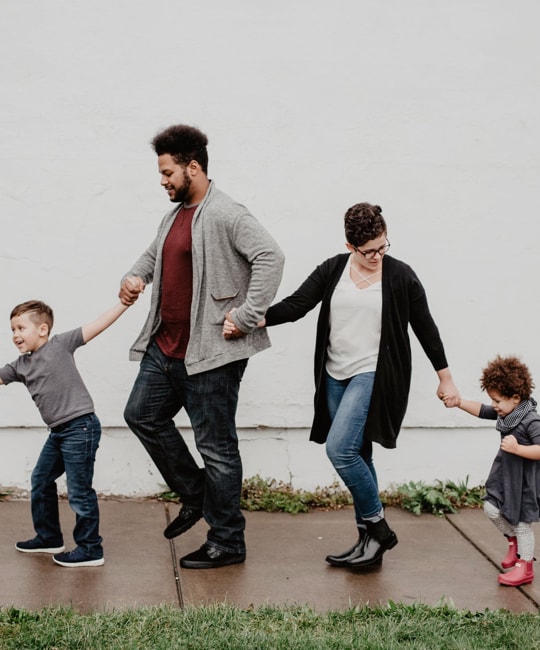 family walking holding hands